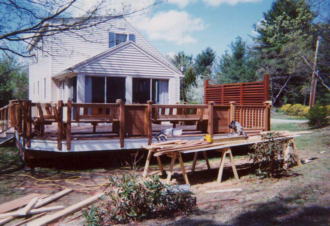 Mahogany deck, screen, benchwork and planters.  Stairs to grade.  Step work in rear.