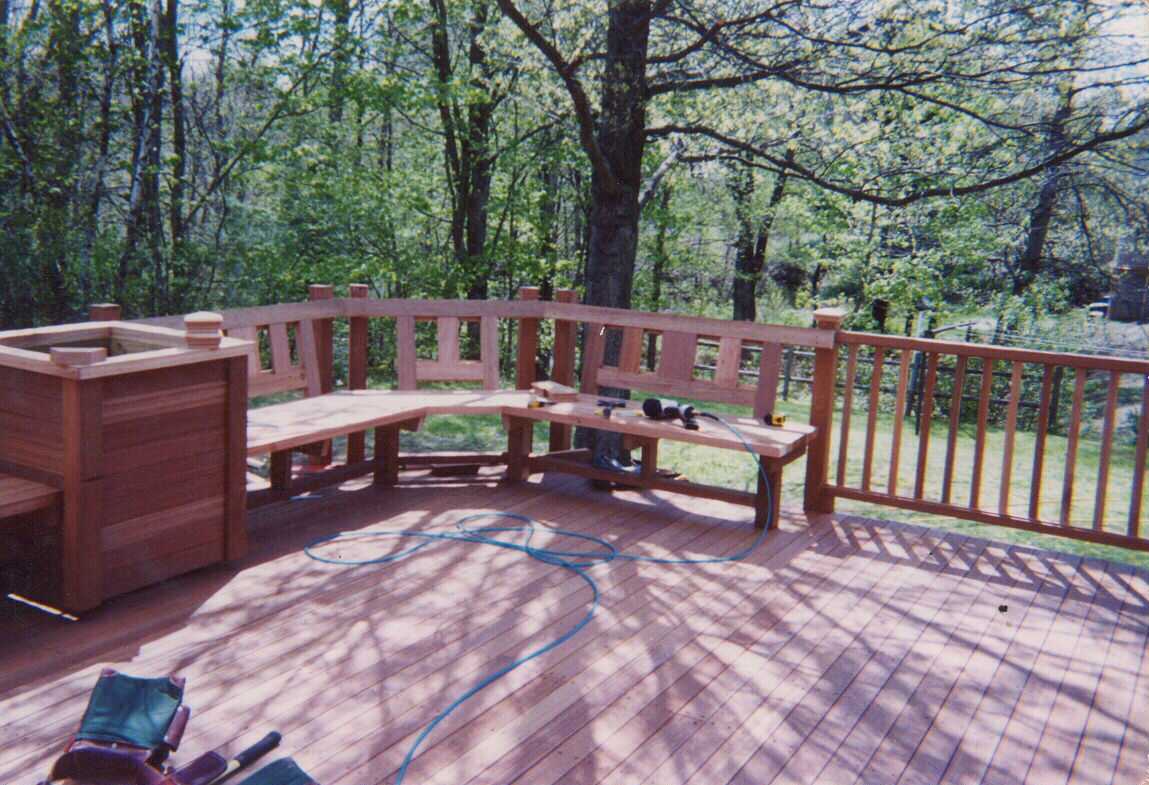 Mahogany deck, screen, benchwork and planters.  Stairs to grade.  Step work in rear.