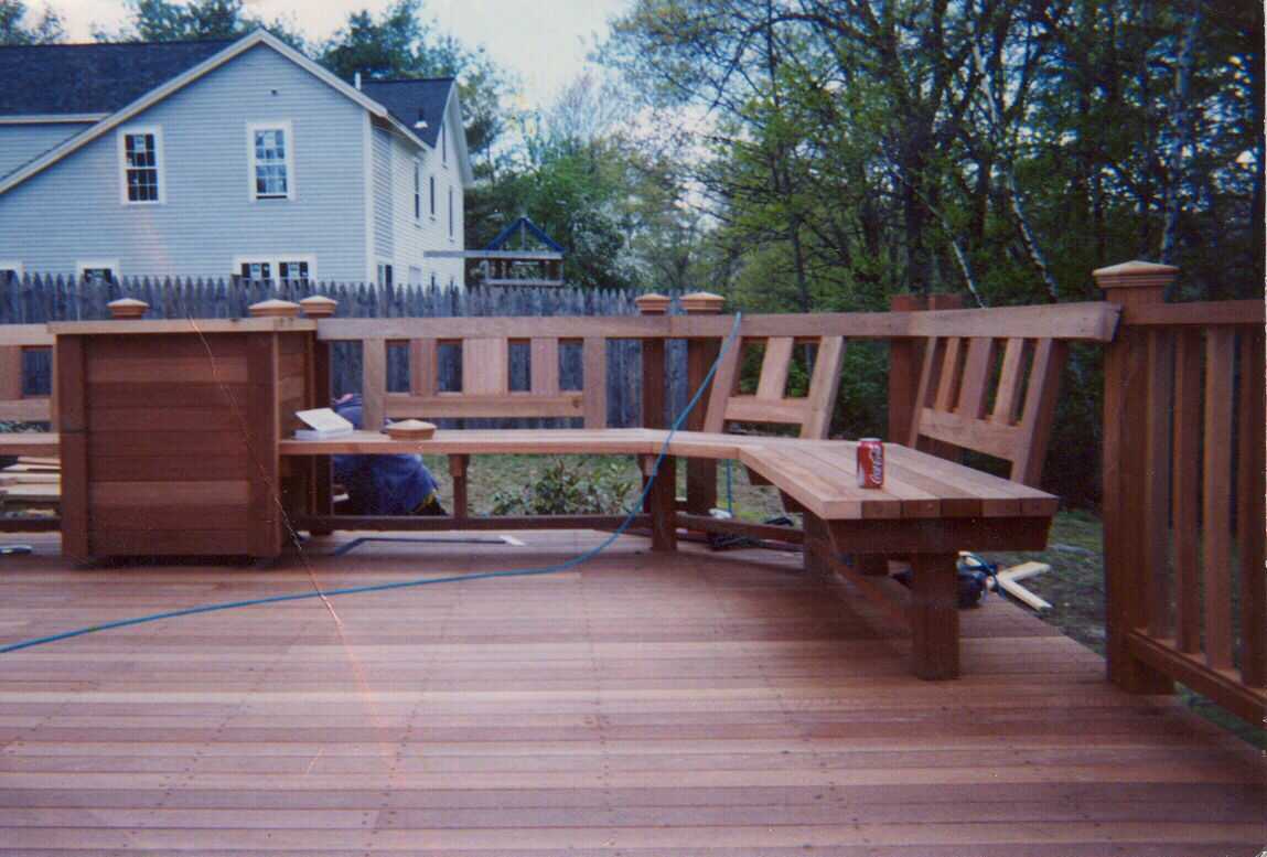 Mahogany deck, screen, benchwork and planters.  Stairs to grade.  Step work in rear.