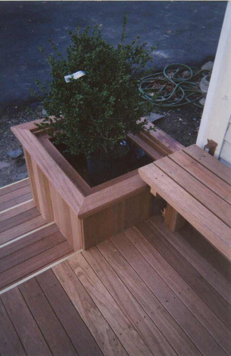 Low level deck with creened room and walk out deck above.  Bench work with planters.