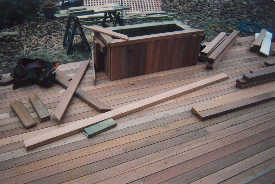 Low level deck with creened room and walk out deck above.  Bench work with planters.