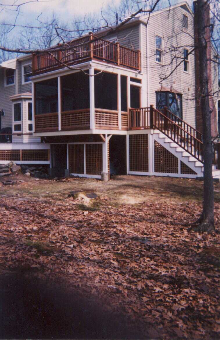 Low level deck with creened room and walk out deck above.  Bench work with planters.