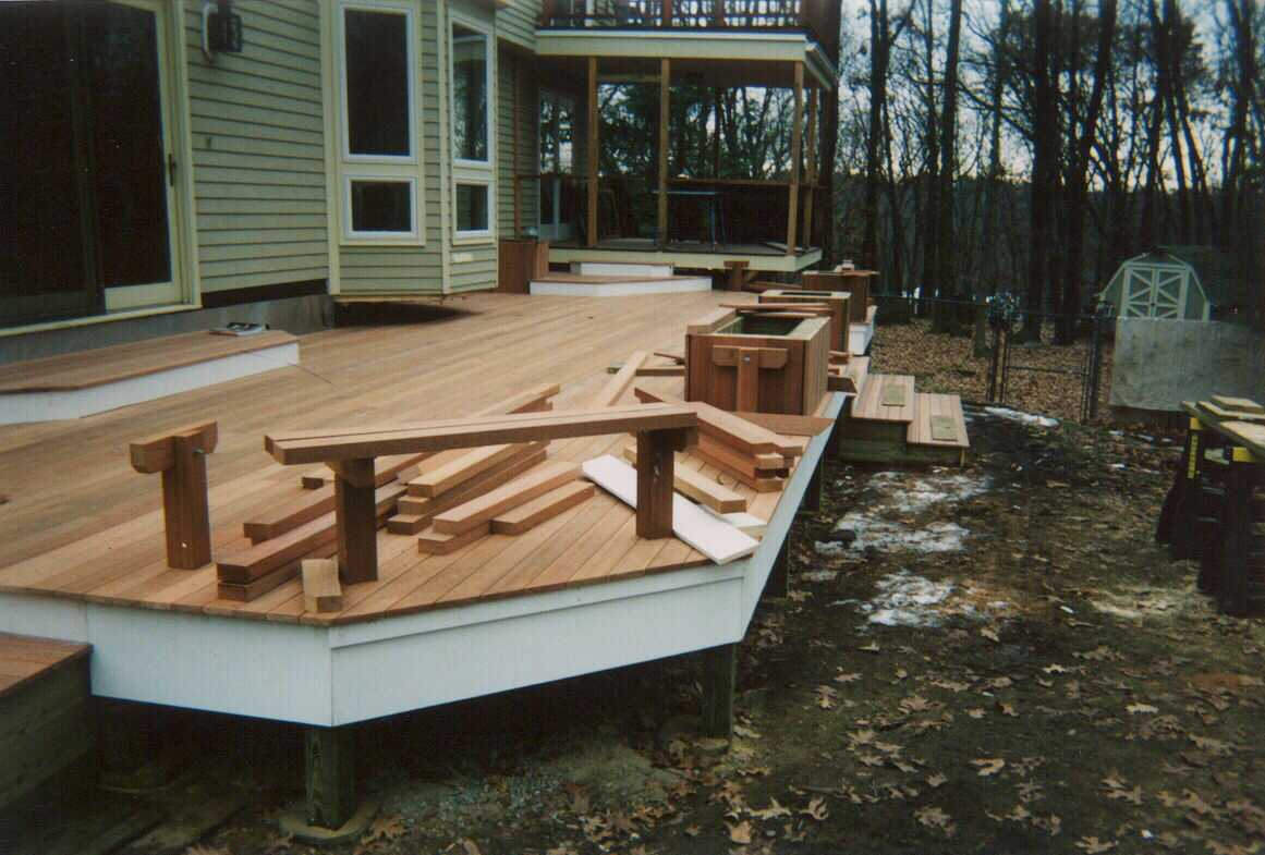 Low level deck with creened room and walk out deck above.  Bench work with planters.