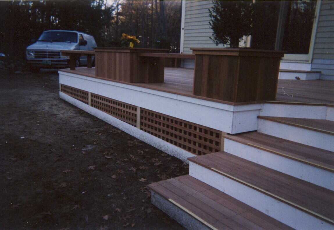 Low level deck with creened room and walk out deck above.  Bench work with planters.