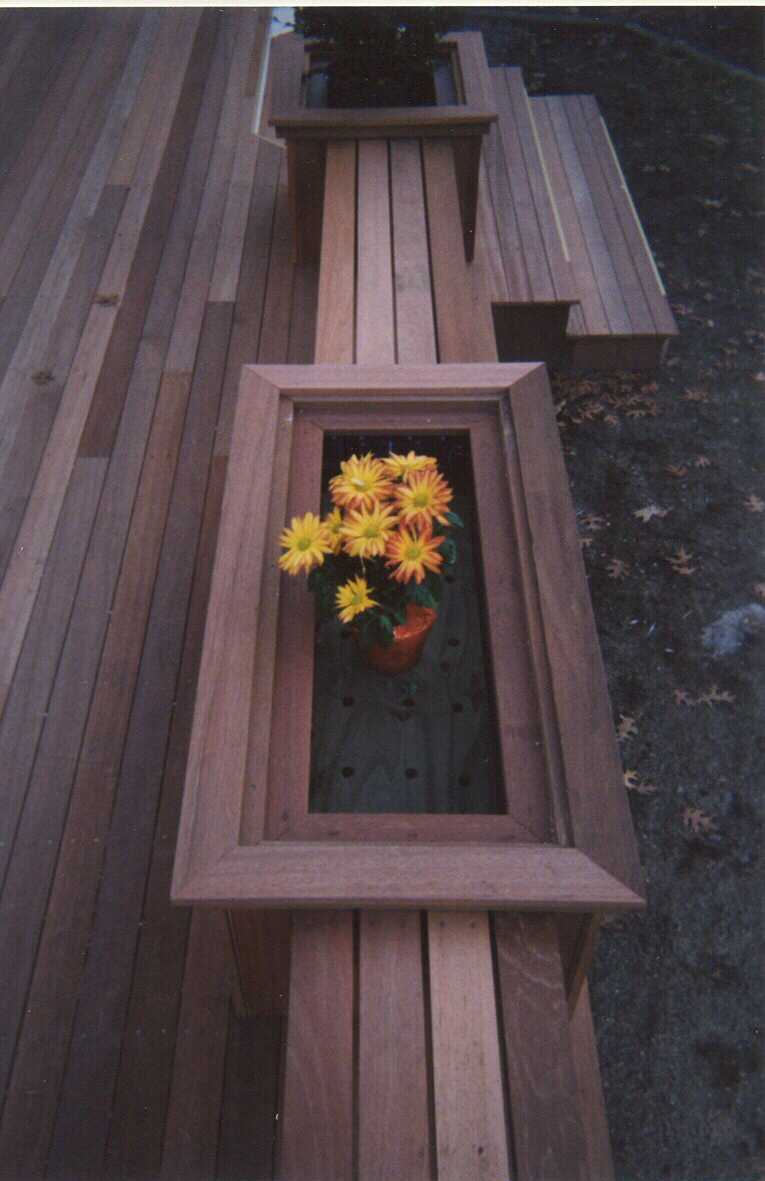 Low level deck with creened room and walk out deck above.  Bench work with planters.