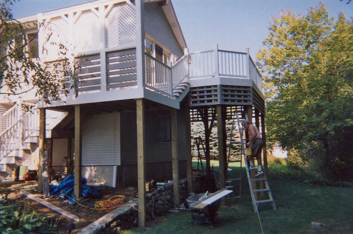 Tall composite deck with privacy screen and stairs.  Also front entry door.